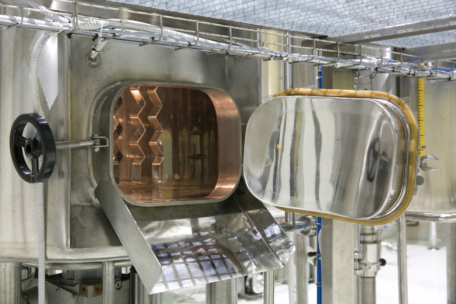 open door of aluminum beer tanks at 'Sknipa' plant